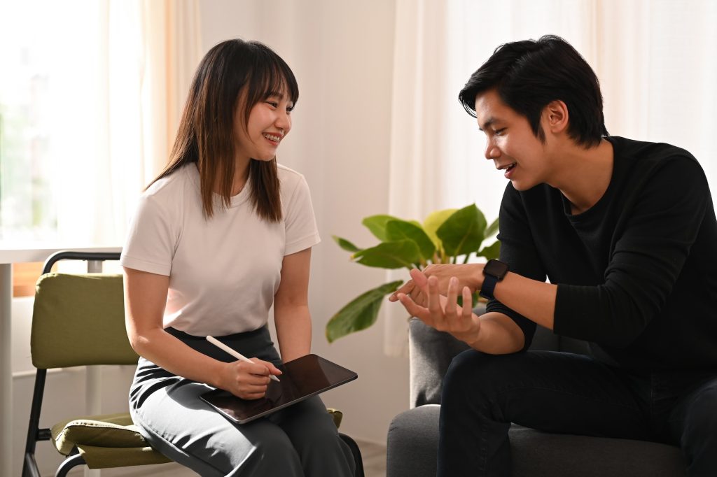 Attentive psychologist is listening to patient at psychotherapy session. Psychology concept.